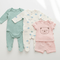 Baby Clothing Sets featuring cute onesies and a t-shirt set for infants in soft colors and playful designs.