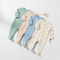 Four colorful baby rompers in pastel shades, perfect for comfort and style in your baby's wardrobe.