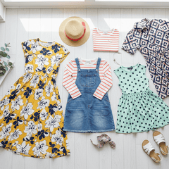 A collection of Girl Dresses, featuring floral, polka dot, and patterned styles on a light background.