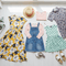 A collection of Girl Dresses, featuring floral, polka dot, and patterned styles on a light background.
