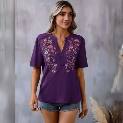 Fashion Flowers Embroidery Lace-collared Blouse in purple with floral embroidery, paired with denim shorts.