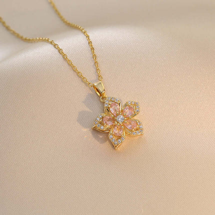 Ins Rhinestones Flowers Unique Rotatable Necklace Pendant showcasing a golden flower design with pink and clear rhinestones.