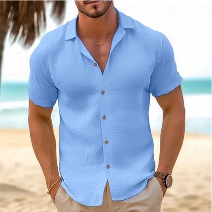 Men Short-Sleeved Button-Down Summer Shirt in light blue worn by a man on a beach background.