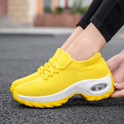 Sports Women Flying Knit Socks Shaking Shoes in bright yellow color worn outdoors with stylish design.