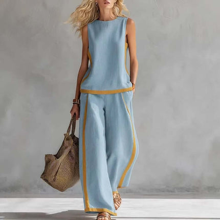 Model wearing a Summer Suits Sleeveless Vest And Wide Leg Pants Set in blue with yellow accents, carrying a stylish bag.