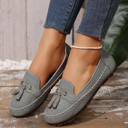 Women Round Head Loafers Non slip Soft Comfortable Flats in grey color worn with jeans.