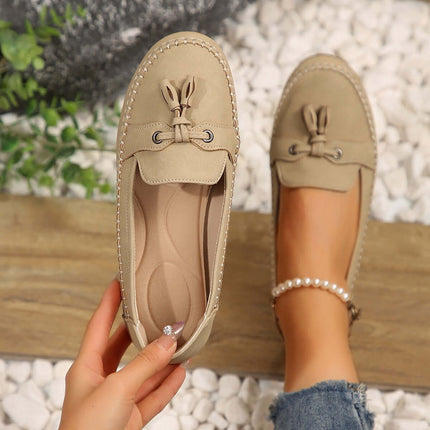 Women Round Head Loafers Non slip Soft Comfortable Flats displayed on a wooden surface with a hand holding one shoe.