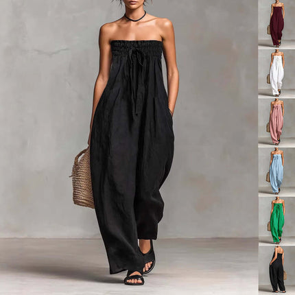 Women Strapless Ruched Jumpsuit Summer Fashion in black, styled with a woven bag and casual sandals.