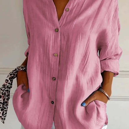 Womens Lapel Long Sleeve Single Breasted Pleated Shirt in pink worn with white shorts and accessories.