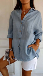 Womens Lapel Long Sleeve Single Breasted Pleated Shirt in light blue color with rolled sleeves and buttons.