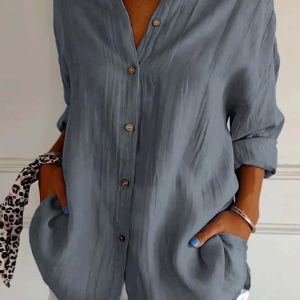 Womens Lapel Long Sleeve Single Breasted Pleated Shirt in light blue with buttons and pockets, styled with white shorts.