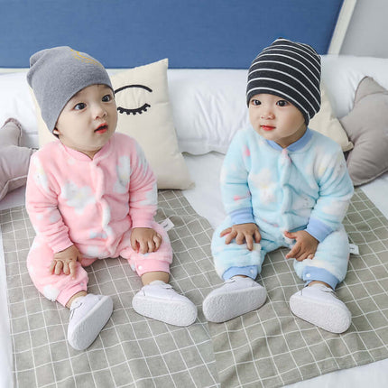 Two babies wearing colorful Baby Long Sleeve Rompers sitting on a bed, one in pink and one in blue.