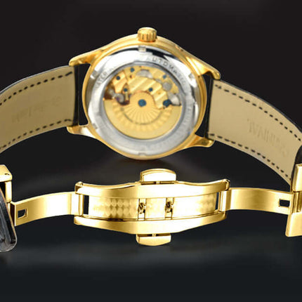 Carnival Full Automatic Mechanical Mens Watch showcasing the intricate gold movement and black leather strap from the back view.