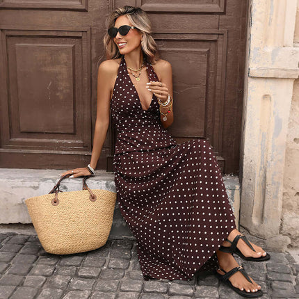 Woman in Casual Dot Slim V-neck Long Dress with sunglasses and straw bag, sitting casually in a vintage setting.