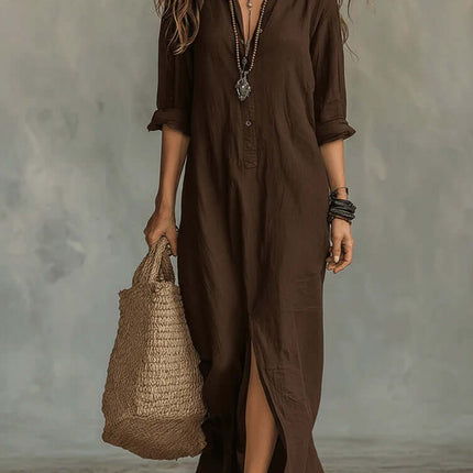 Casual Solid Color Lapel Side Slit Maxi Dress model wearing a brown dress with a side slit and carrying a straw bag.