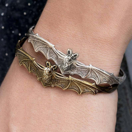 Creative Gothic Bat Charm Bracelet Halloween Jewelry featuring silver and gold bat designs on a wrist.