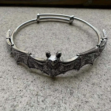 Creative Gothic Bat Charm Bracelet Halloween Jewelry displayed on a stone surface with detailed bat design.