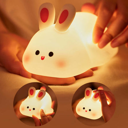 Cute Rabbit LED Night Light Soft Silicone Touch Lamp being held in hands, soft and glowing, ideal for children's rooms.