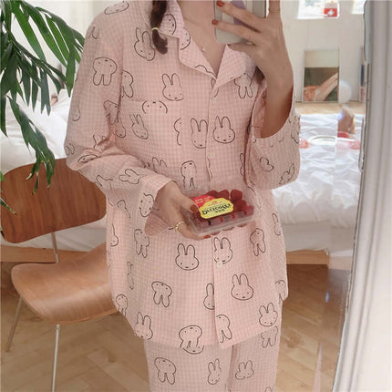 Cute Rabbit Pajamas For Women Sweet Cardigan Suit worn by a woman holding snacks in a cozy bedroom setting.