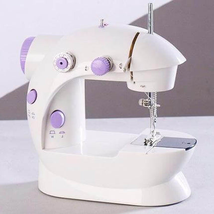 Electric Mini Household Multifunctional Sewing Machine on a table with purple accents.