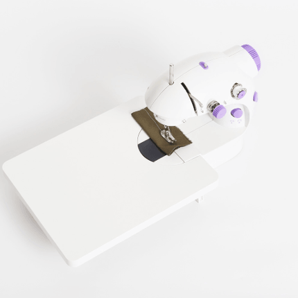 Electric Mini Household Multifunctional Sewing Machine on a white background with fabric being sewn.