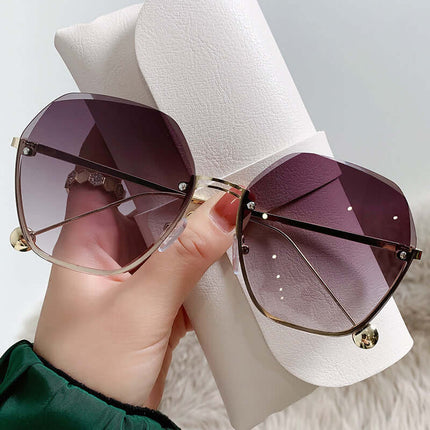 Elegant Fashion Sunglasses for a Slimming Face Look held with a stylish case.