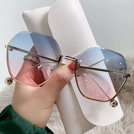 Elegant Fashion Sunglasses for a Slimming Face Look in stylish oversized design, held against a white case.