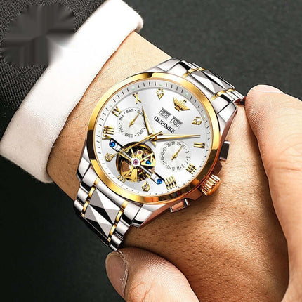 Elite Hollow Mechanical luxury mens watch with a silver and gold stainless steel band on a wrist.
