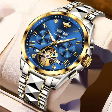 Elite Hollow Mechanical: Luxury mens watch with blue dial and gold accents displayed on a cushioned holder.