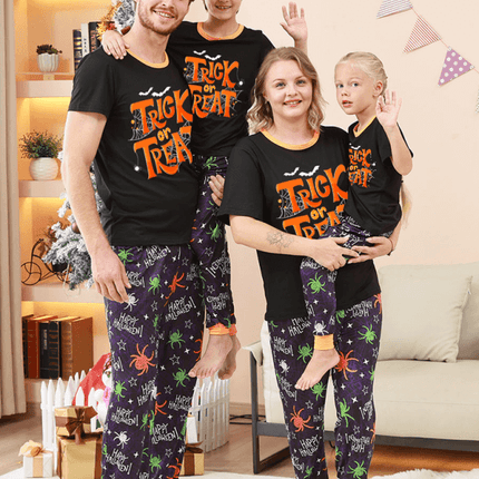 Family Matching Holiday Pajamas – Spider Printed Loungewear for Halloween and Christmas in a cozy living room.