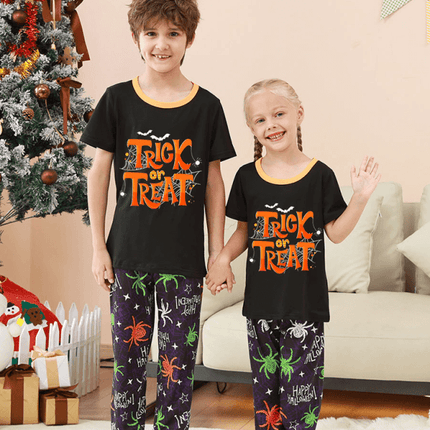 Family Matching Holiday Pajamas – Spider Printed Loungewear for Halloween and Christmas worn by kids in a festive setting.