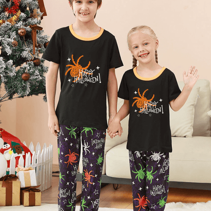 Family Matching Holiday Pajamas – Spider Printed Loungewear for Halloween and Christmas worn by kids in a festive home setting.