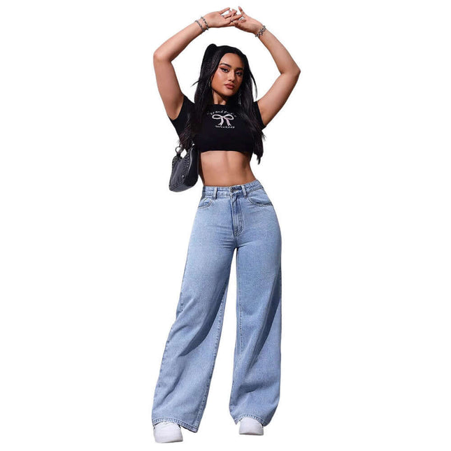 Floor Length Flared Straight Leg Denim Jeans For Women modeled by a woman wearing a crop top and holding a handbag.