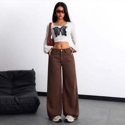 Woman wearing Floor Length Flared Straight Leg Denim Jeans For Women with butterfly crop top and sunglasses, posing indoors.