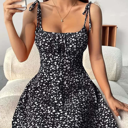 Floral Print Summer Sweet A Line Mini Dress modeled by a woman sitting and holding a phone, featuring a cute floral design.