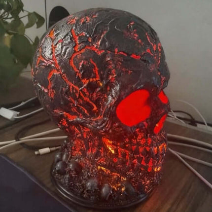 Halloween Lava Stone Skull Lamp glowing with red light, decorated in a spooky style, perfect for Halloween decor.
