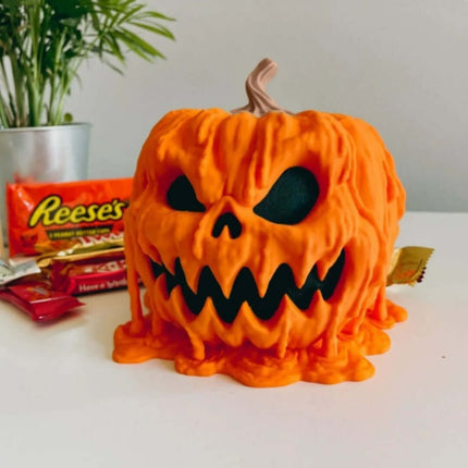 Halloween Melting Pumpkin Candy Bowl With Lid featuring a dripping design and black eyes.