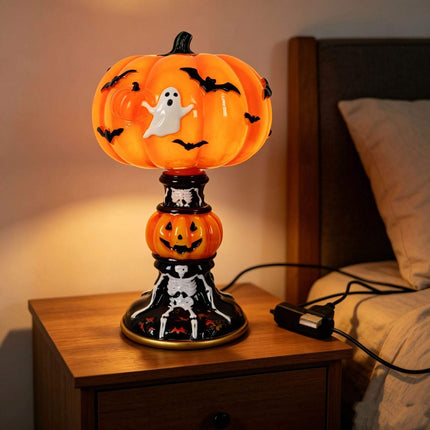 Halloween Night Light USB Powered Pumpkin Lamp illuminating a bedside table, featuring a ghost and bats design.