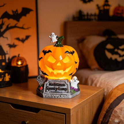 Halloween Night Light USB Powered Pumpkin Lamp with spooky design and ghost accents on bedside table.