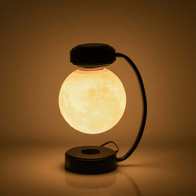 Magnetic levitating moon lamp glowing softly while floating in mid-air against a dark background.