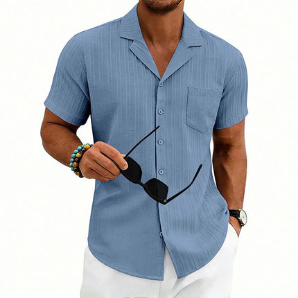Men's Casual Cuban Neck Short Sleeve Shirt in light blue, model holding sunglasses, styled for summer fashion.