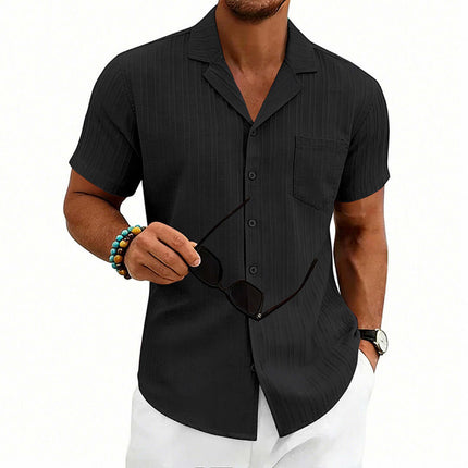 Men's Casual Cuban Neck Short Sleeve Shirt in black, worn by a man holding sunglasses.