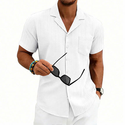 Men's Casual Cuban Neck Short Sleeve Shirt worn by a man holding sunglasses.