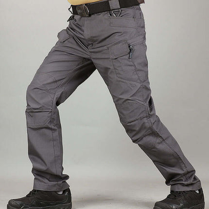 Mens Special Service Outdoor Tactical Training Pants worn by a model in a dynamic pose, showcasing functionality and versatility.