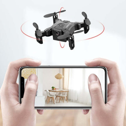 Mini Folding Drone 4K HD Aerial Photography UAV flying above a smartphone displaying interior photography.