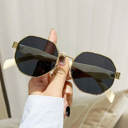Modern Square Polygon Metal Sunglasses Full Frame UV400 held in hand with dark lenses and gold frame.