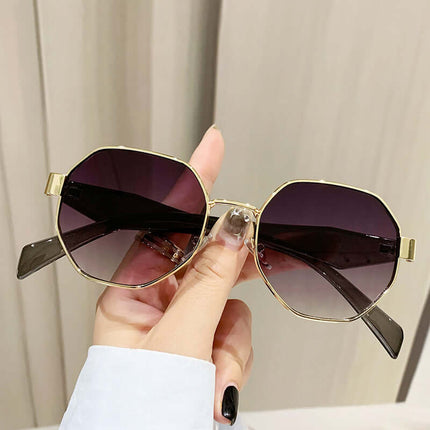 Modern Square Polygon Metal Sunglasses Full Frame UV400 held in hand with dark lenses and gold frame.