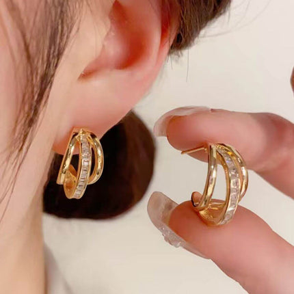 New Trendy Womens High grade Geometric Zircon Earrings displayed in a close-up of a woman wearing them.