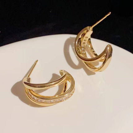 New Trendy Womens High grade Geometric Zircon Earrings displayed on a white plate.