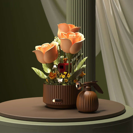 Preserved flower building blocks model with orange flowers and decorative elements on a stylish table.